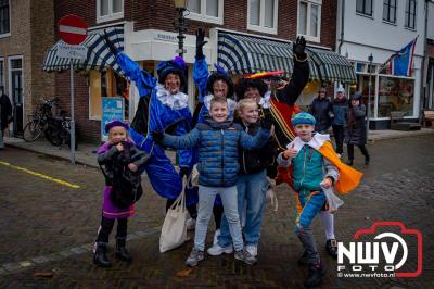 Kinderen genieten volop van de feestelijke aankomst van Sinterklaas op zijn stoomboot, gevolgd door een vrolijke stoet van Pietenboten in de haven van Elburg. - © NWVFoto.nl