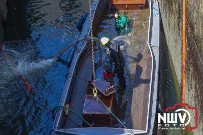 Sloep schept water en zinkt in sluis door dat touw aan haakse geleider bleef haken. - © NWVFoto.nl